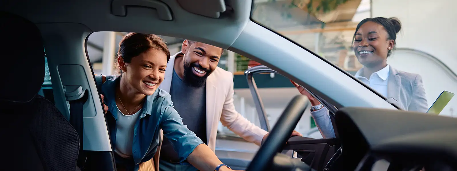 Two happy people celebrating their car purchase, exploring rent-to-own options.