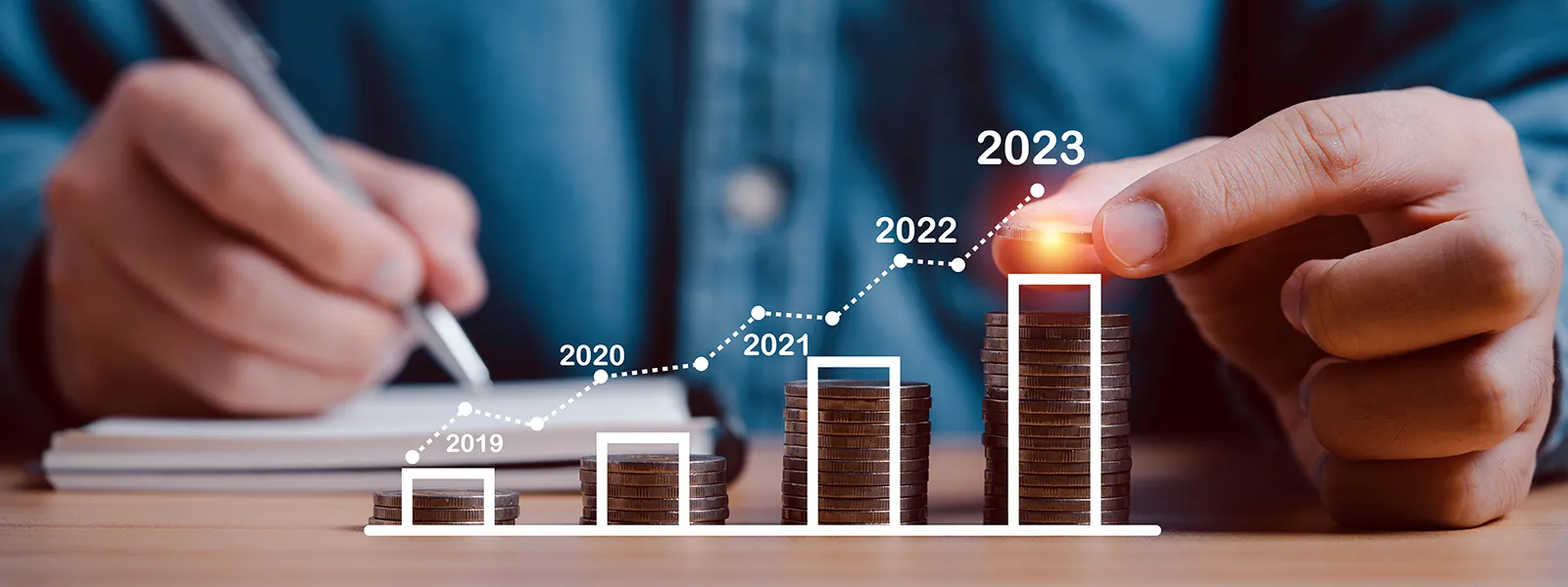 Man stacking coins into piles with a graph showing growth from 2019 to 2023.