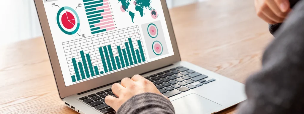 Close-up of a man analyzing graphs on his laptop.